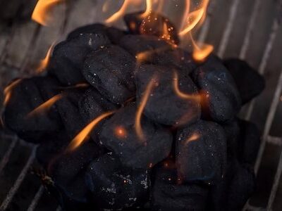 macro closeup of flames on charcoals in barbecue pit
